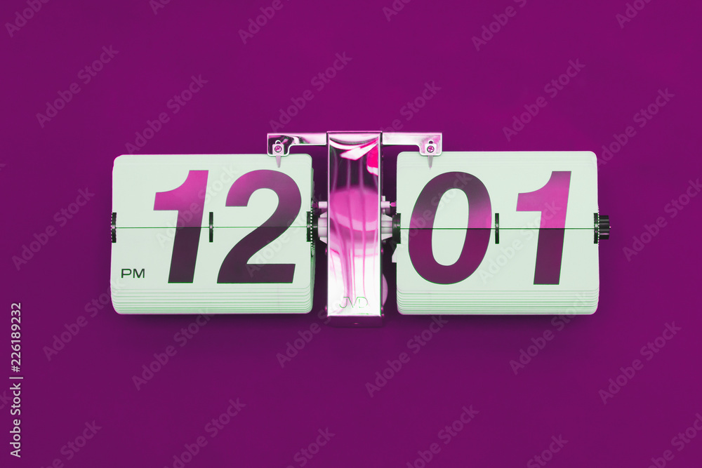 12:01 on the clock, purple background 12:01 on the clock, purple background