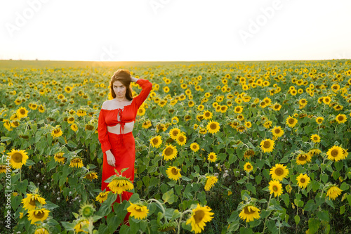 Beauty joyful girl in sunflower field