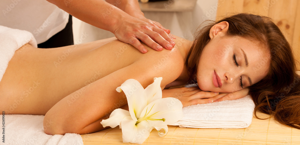 Body care. Spa body massage treatment. Woman having massage in the spa salon  Stock Photo | Adobe Stock