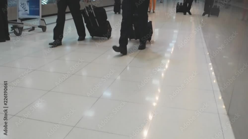 Traveller passenger walking with suitcase at airport Traveller passenger walking with suitcase at airport