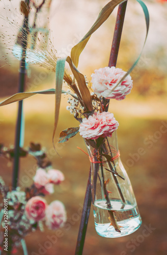 Autumn wedding decoration withwild roses in glass