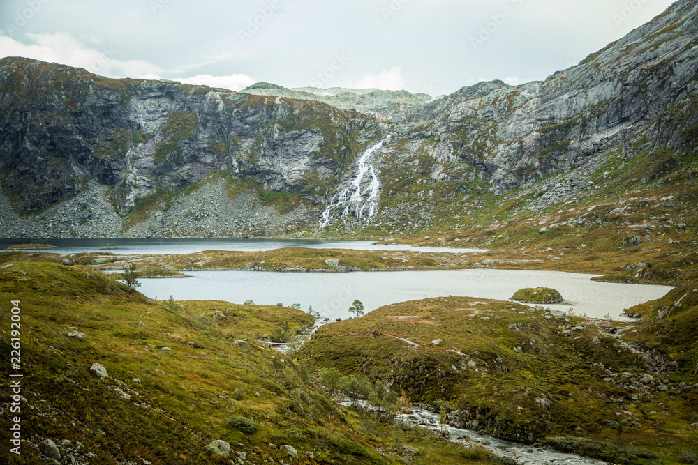 A beautiful landscape of a mountain lake in Folgefonna National Park in Norway. Overcast autumn day in mountains. Autumn scenery of lake.