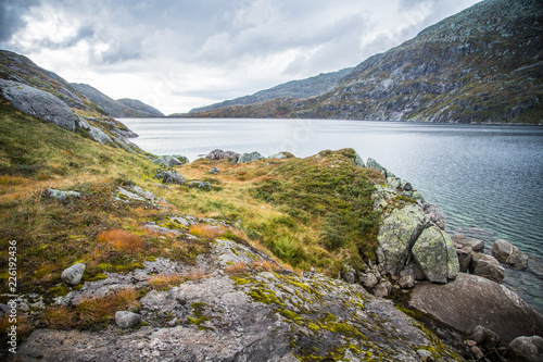 A beautiful landscape of a mountain lake in Folgefonna National Park in Norway. Overcast autumn day in mountains. Autumn scenery of lake.