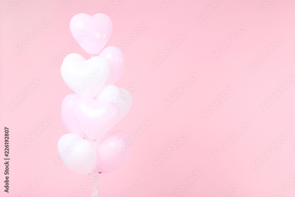 Heart balloons on pink background
