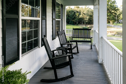 Front Porch of Southern home with Black Rocking Chairs and a Casual Feel photo