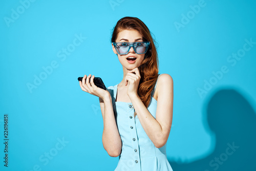 confident woman in a dress on a blue background