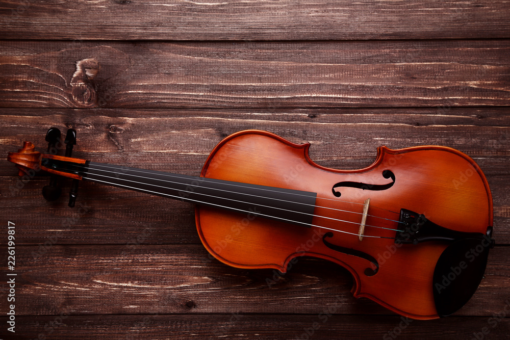 Fototapeta premium Violin on brown wooden table