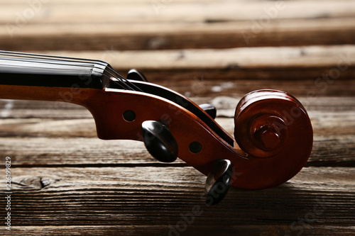 Violin head on brown wooden table