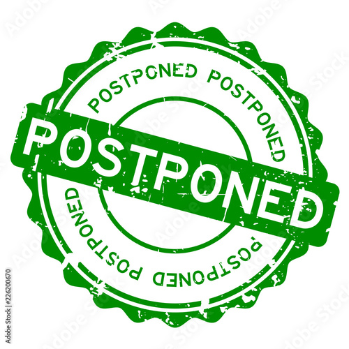Grunge green postponed word round rubber seal stamp on white background