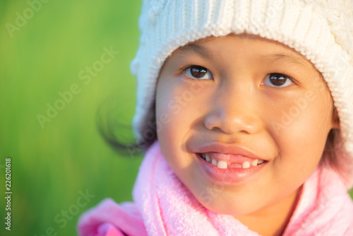 Portrait of young beautiful asian girl outdoor in winter with warm blured sunset light.