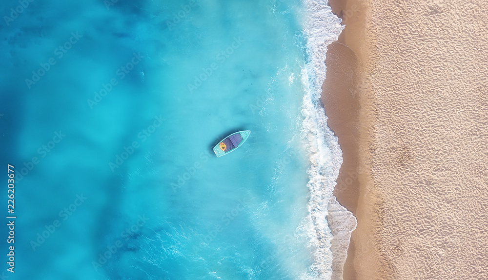 Boat on the water surface from top view. Turquoise water background from top view. Summer seascape from air. Travel concept and idea