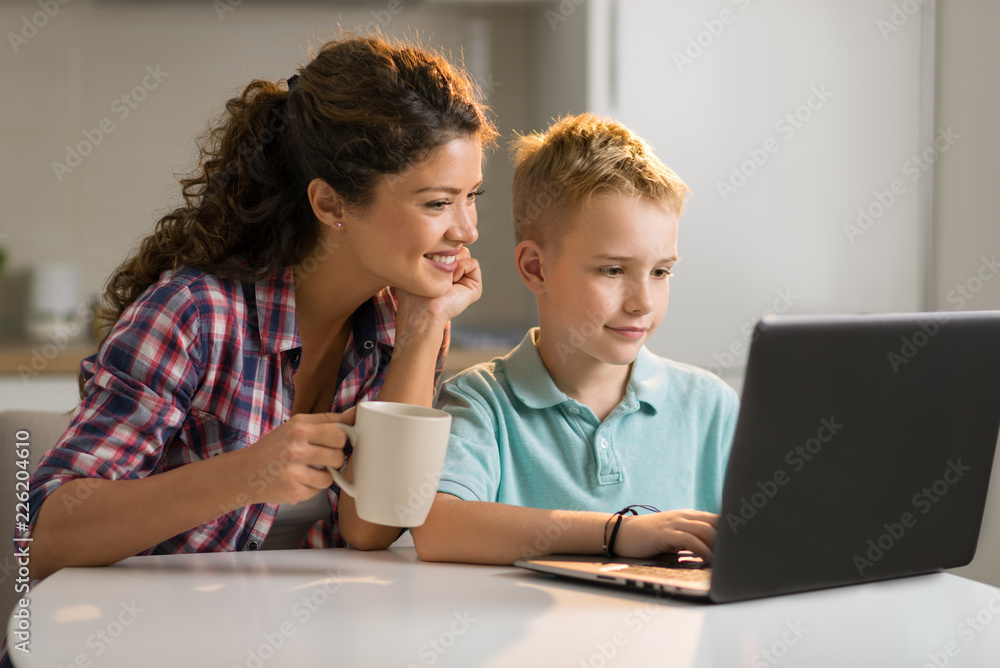 Little boy and his mother using laptop Little boy and his mother using laptop