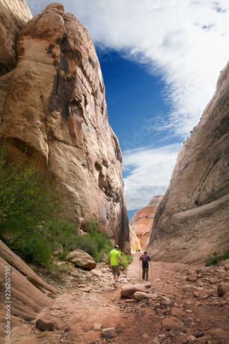 Father and son are on the path in the mountains. Capitol Reef National Park, Utah, USA