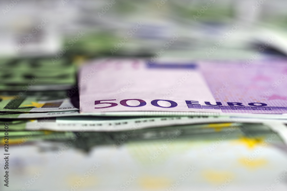 European euro currency bank notes lying on a desk close-up, symbolizing finance and business. European euro currency bank notes lying on a desk close-up, symbolizing finance and business.