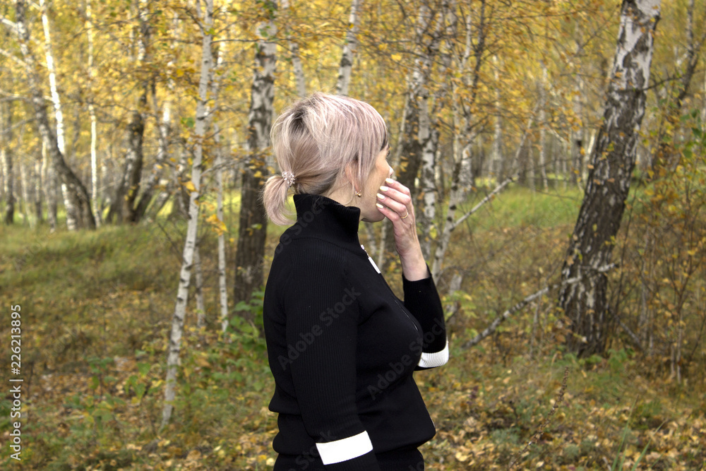 the girl in the forest stands alone and looks around the girl in the forest stands alone and looks around