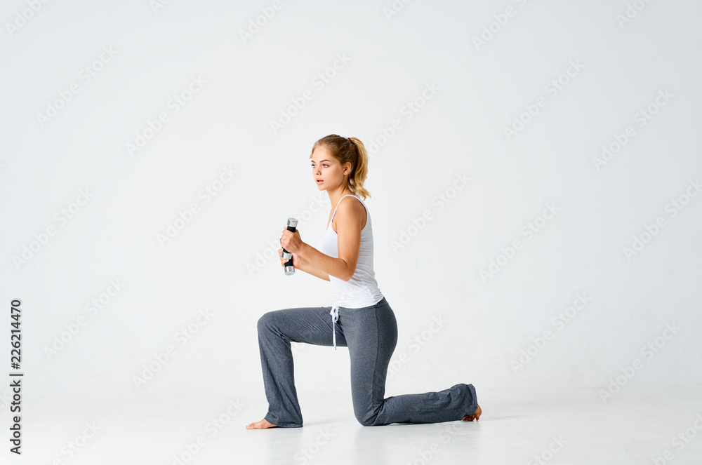 woman crouches with dumbbells woman crouches with dumbbells