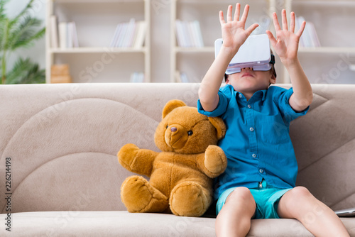 Young little boy with VR virtual reality glasses photo