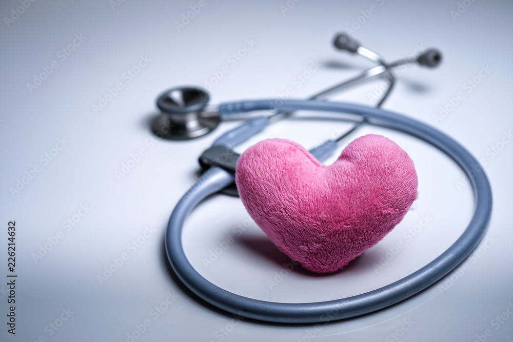 Grey stethoscope with pink heart shape on white isolated background Grey stethoscope with pink heart shape on white isolated background