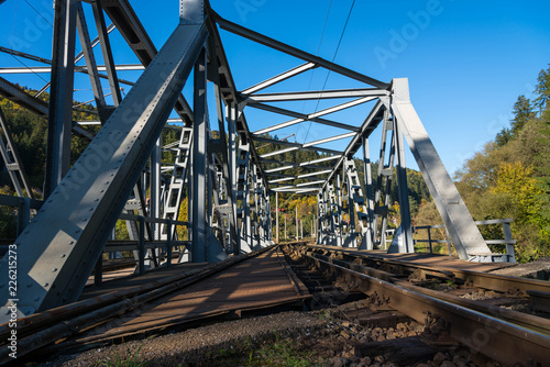 Steel railroad bridge close up on a bright autumn day . © Alpar