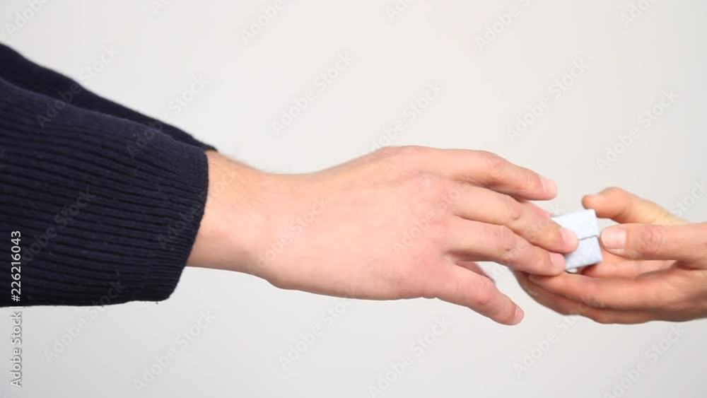 Hands giving and receiving a present Hands giving and receiving a present
