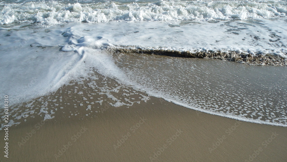 onde e schiuma sulla riva del mare Stock Photo | Adobe Stock