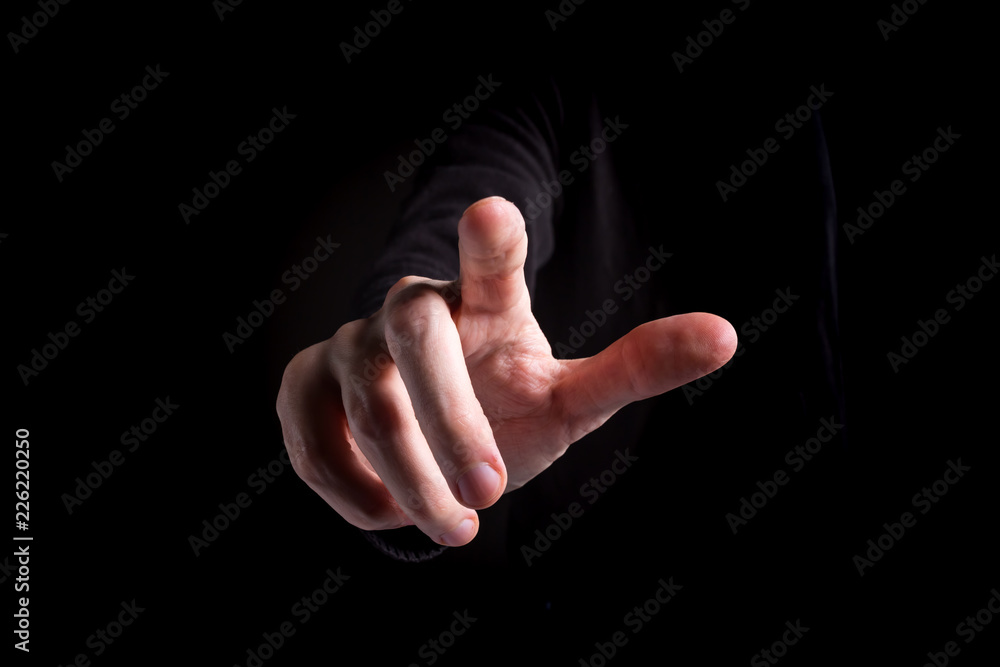 Man pointing or pressing something on black background Man pointing or pressing something on black background