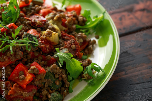 Lentil salad with roasted red pepper, zucchini and dry tomatoes, lemon. healthy food, vegetarian and vegan style photo