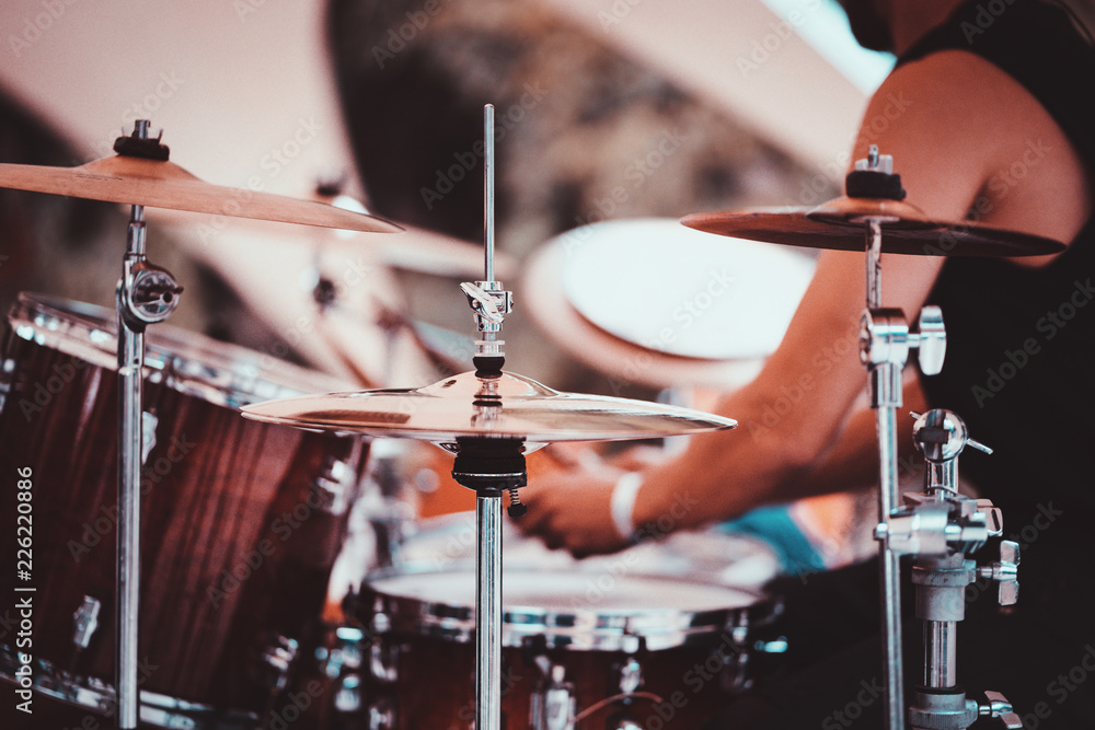 Naklejka premium Unidentified drummer playing on drum kit. Close up of play drums. Drum player kick drum plate. Man playing drums music.