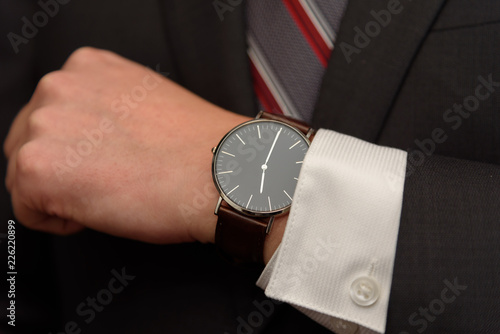 businessman in suit, tie and wrist watch