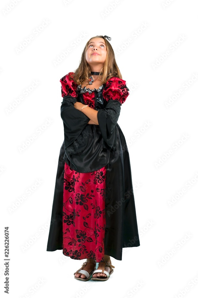 A full-length shot of a Blonde child dressed as a vampire for halloween holidays stand and looking up isolated on white
