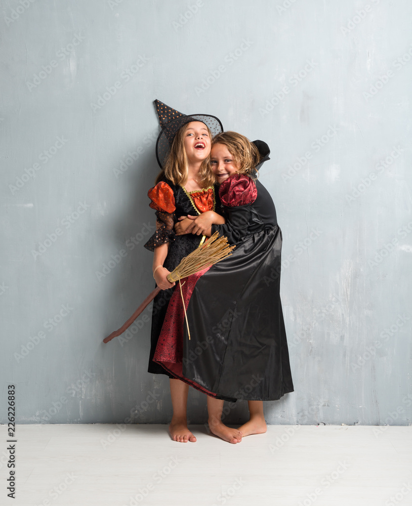 Fototapeta premium Group of friends with costumes of vampires and witches hugging for halloween holidays