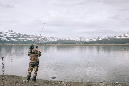 Fishing on the mountain river. Trout fishing. Fisherman fishing in the mountains