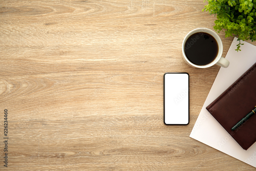 phone with isolated screen on wooden table near notebook coffee phone with isolated screen on wooden table near notebook coffee