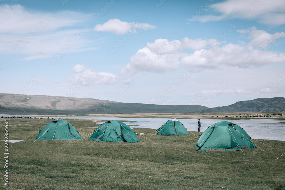 a lot of tourists tents camping in mountains. Mongolia