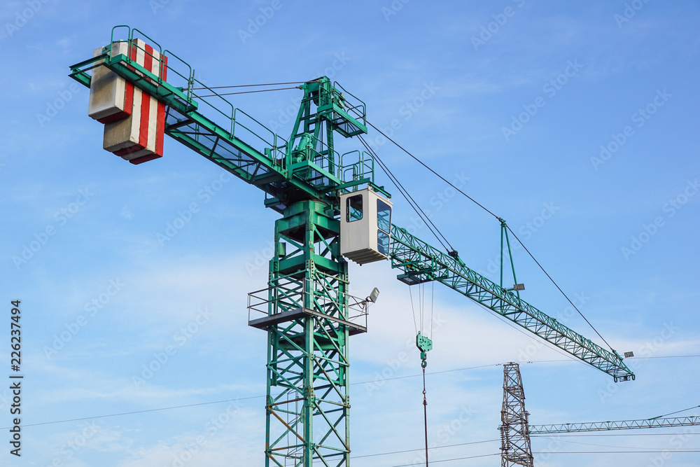 crane tower on sky background at construction site