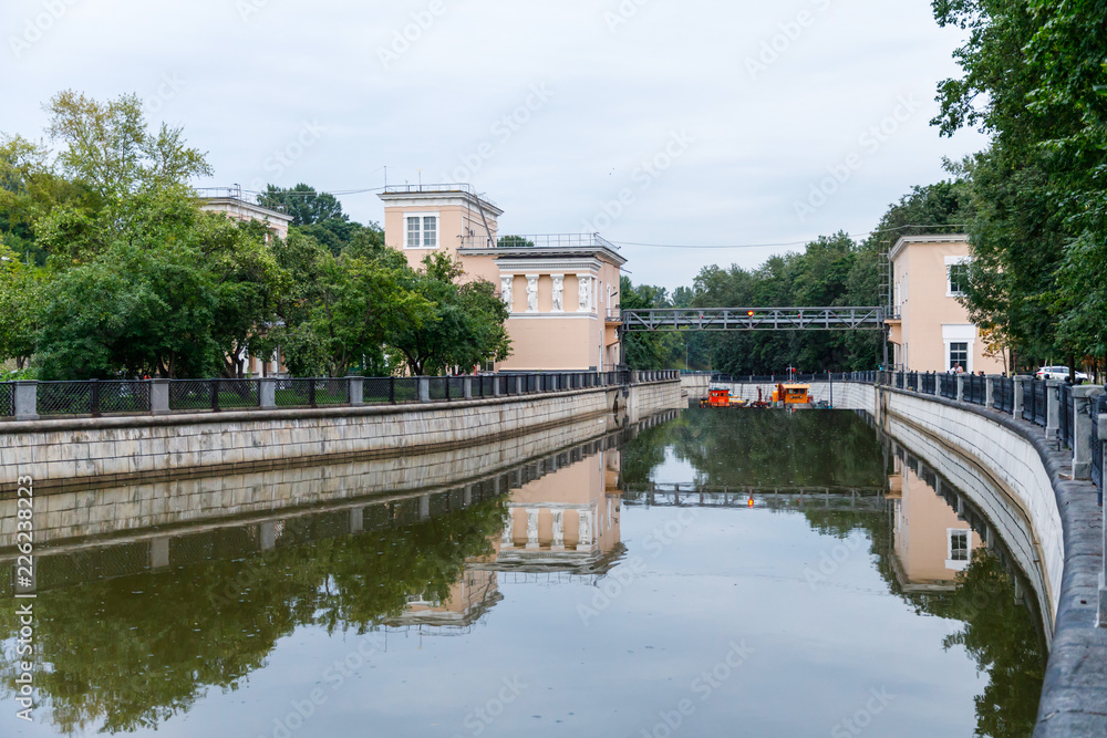 Yauza river with two sluices of Syromyatnicheskiy waterworks against the cityscape in Moscow