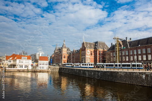 Canals, central railway station and tram at the Old Central district of Amsterdam