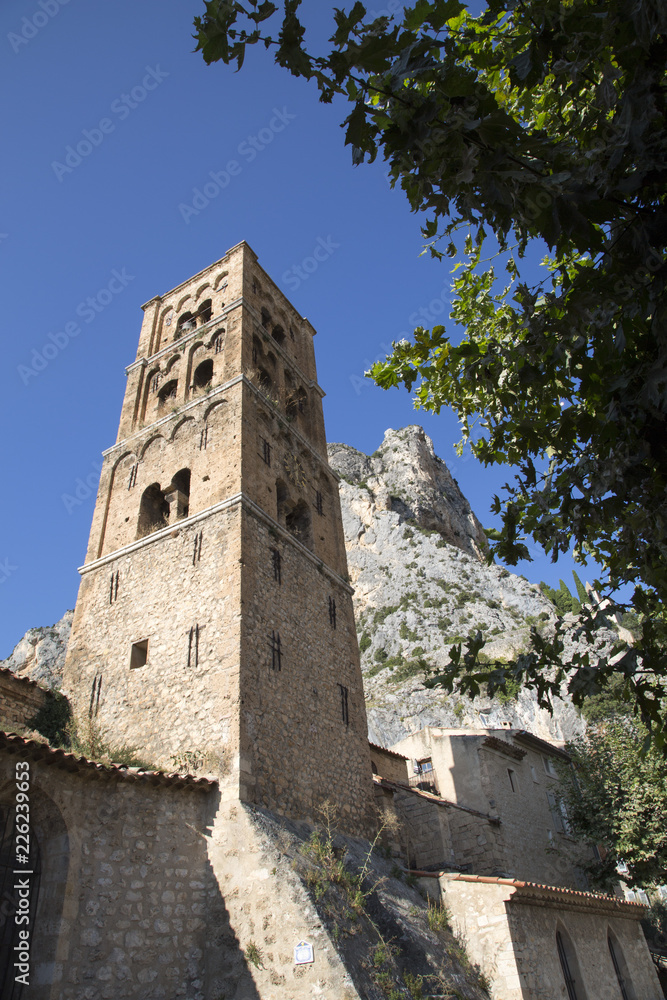The tenth century village of Moustiers-Sainte-Marie in the Alpes-de-Haute-Provence and the tower of Notre-Dame-de-l'Assomption The tenth century village of Moustiers-Sainte-Marie in the Alpes-de-Haute-Provence and the tower of Notre-Dame-de-l'Assomption