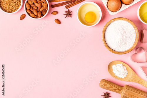 Ingredients and utensils for baking on a pastel background.