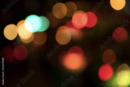 Blurry background image of defocused colorful lights at night © jokerpro