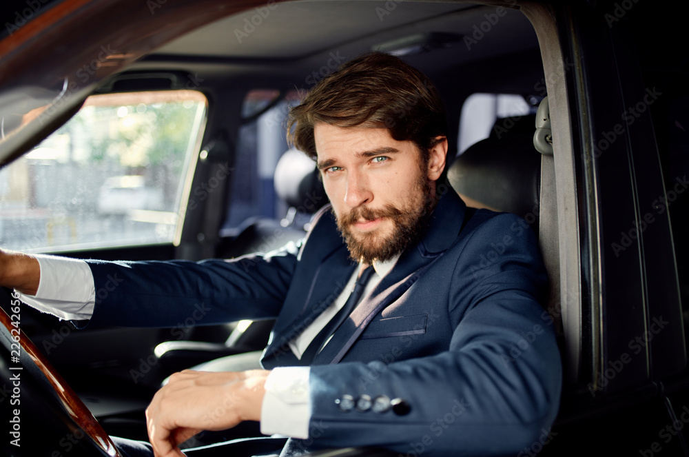 business man looking at the camera drives the car business man looking at the camera drives the car