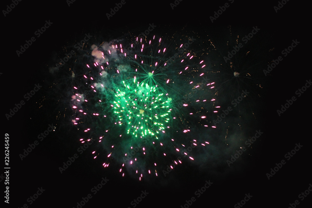 Fireworks. Salute. Sky background Amazing mystery of green and violet