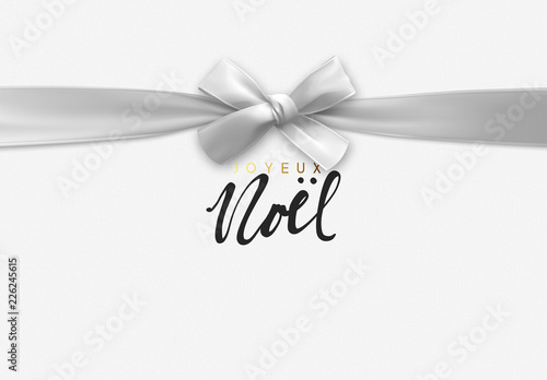 French lettering Joyeux Noel. Merry Christmas Holiday background. Handwritten text, realistic textured pattern, pull ribbon bow.