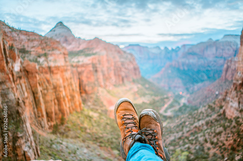 Close up of man wearing mountain boots and landscape of mountains photo