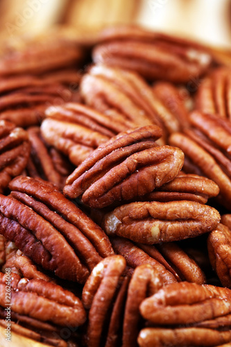 Pecan nuts on a table and pecan nuts in bowl