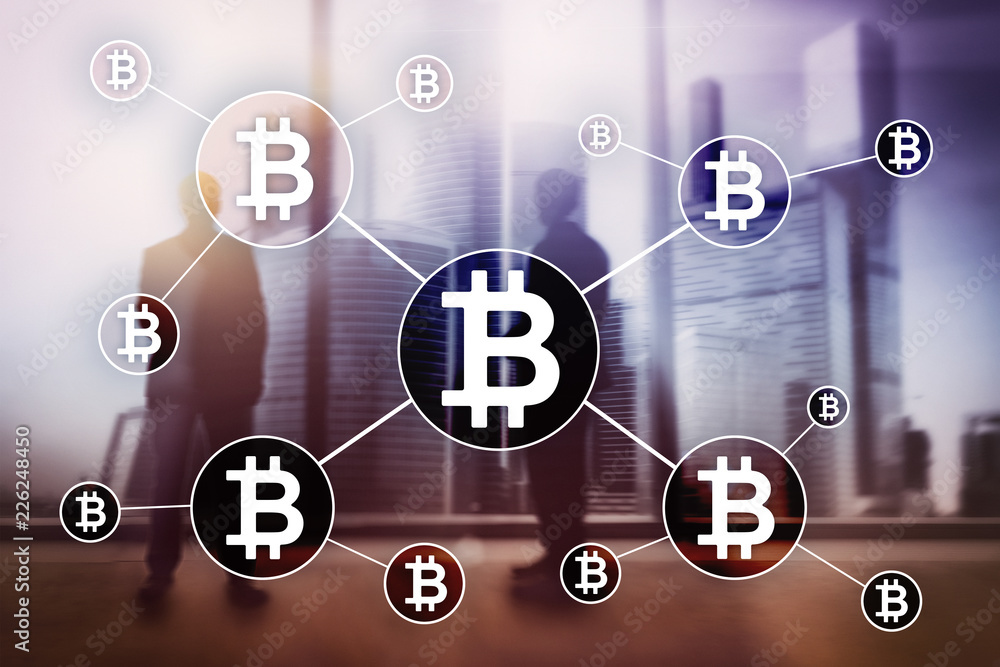 Bitcoin cryptocurrency and blockchain technology concept on blurred skyscrapers background. Bitcoin cryptocurrency and blockchain technology concept on blurred skyscrapers background.