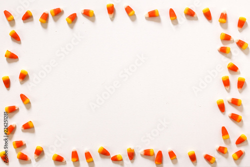 Candy Corn Frame against a white background Top View Flat Lay, Modern Halloween Concept with Copy Space