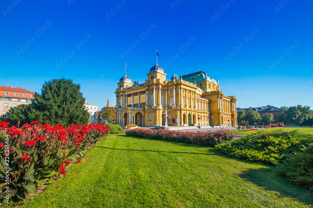     Croatian national theater building and flowers in park in Zagreb, Croatia 