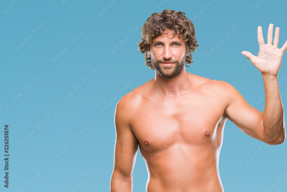 Handsome hispanic model man sexy and shirtless over isolated background showing and pointing up with fingers number five while smiling confident and happy.