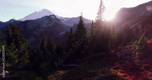 Flying over dramatic alpine landscape in autumn towards Mount Baker at dusk